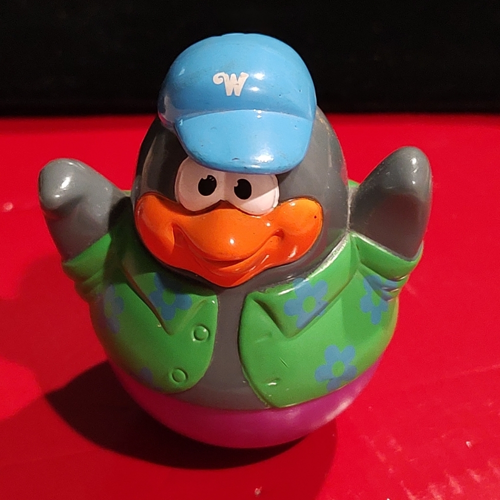 Hasbro Playskool 2004 Weeble Wobble toy penguin a green floral shirt blue cap